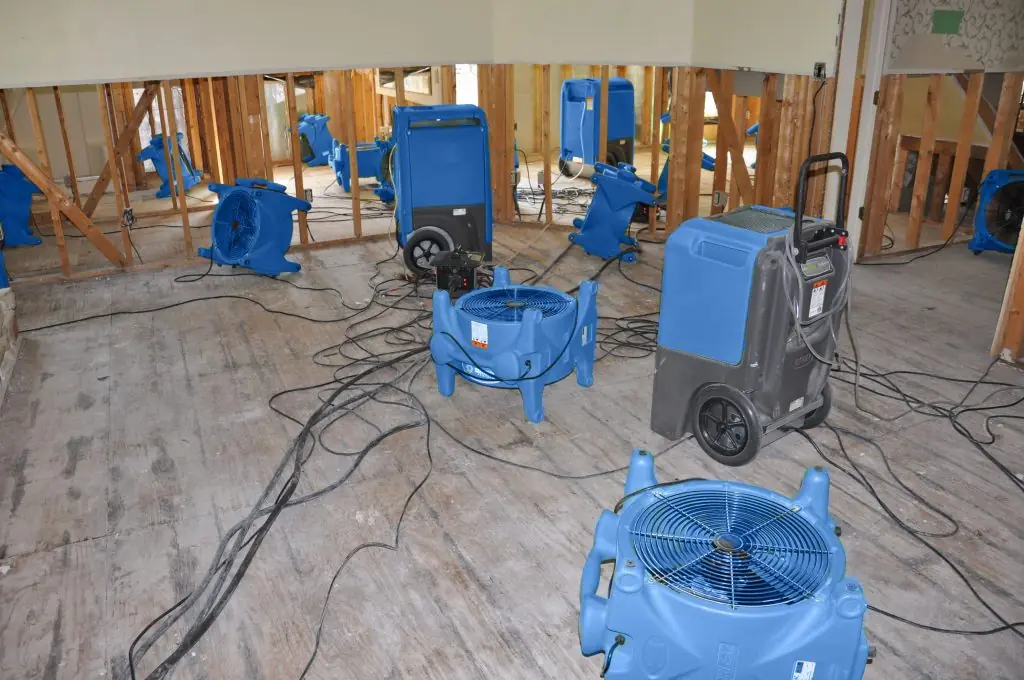 Air movers drying a gutted Little Rock room after major water damage